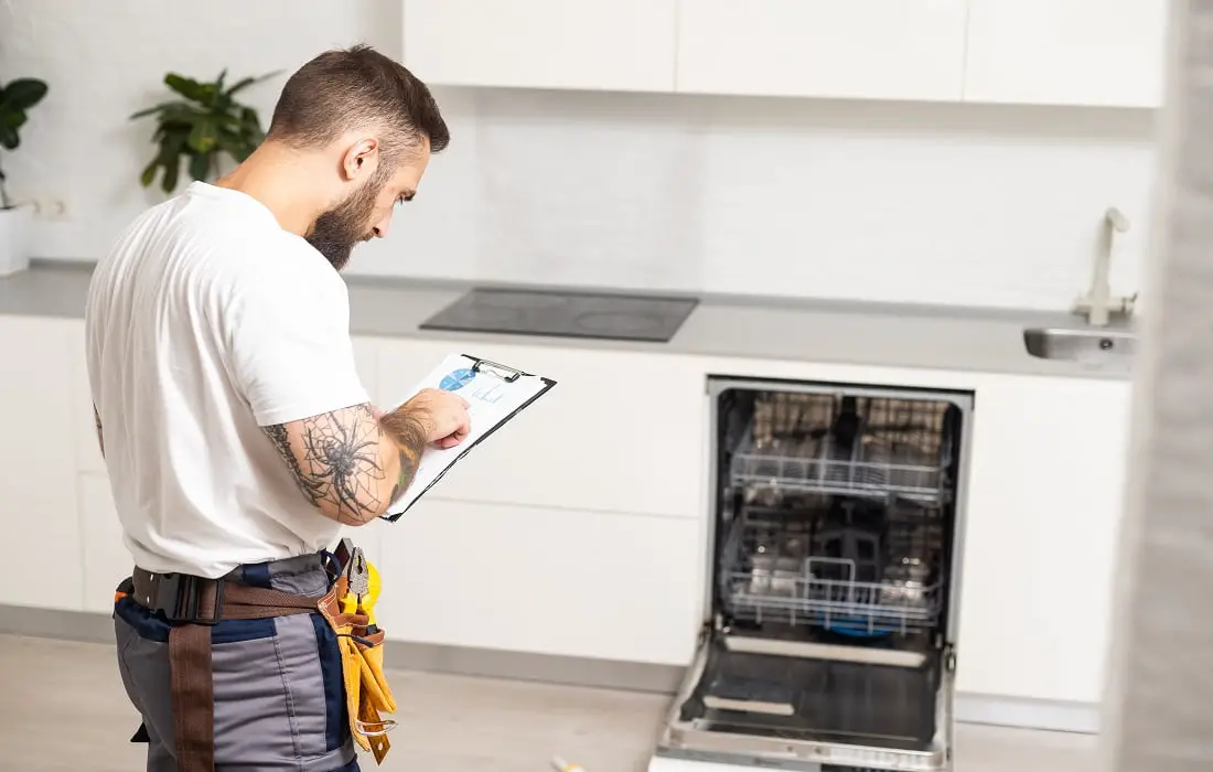 Worker estimating cost for broken dishwasher