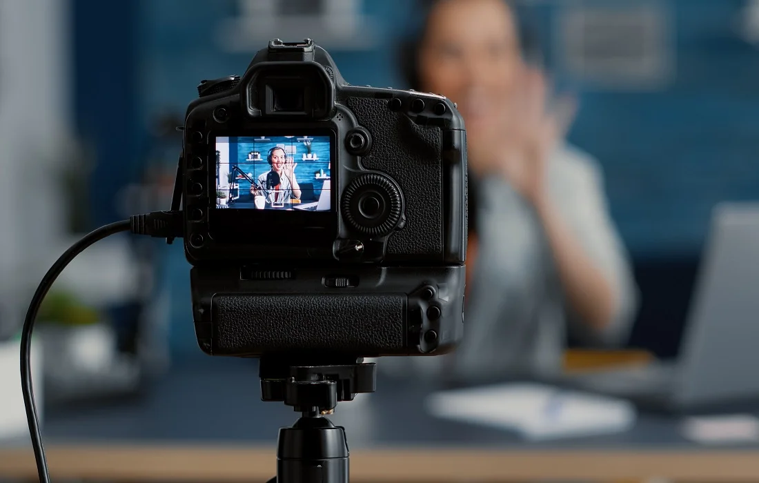 How to Start a Successful YouTube Channel in 2023 and Grow Your Audience 2 Modern camera filming influencer talking to audience