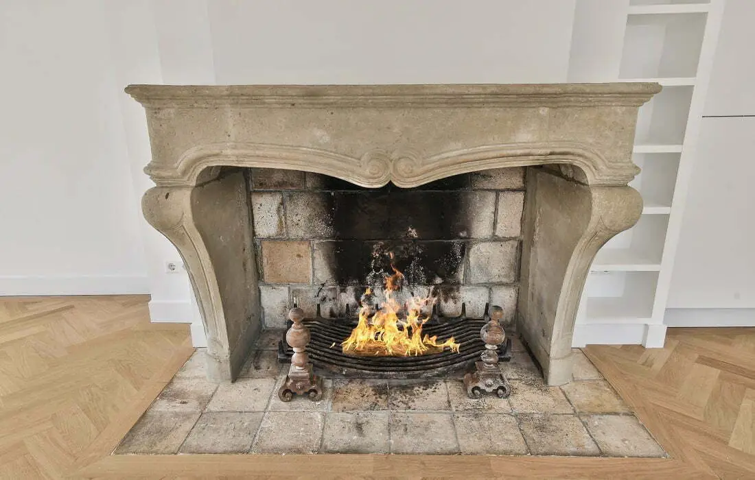 A-stone-fireplace-with-a-roaring-fire-in-a-room