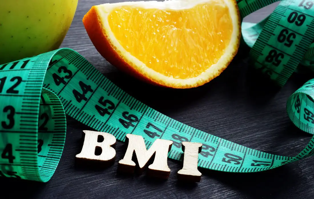 Letters-bmi-body-mass-index-with-measuring-tape-and-orange