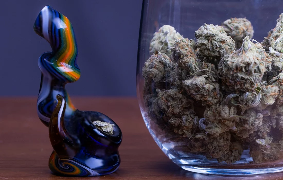 Brown and white flowers in clear glass vase